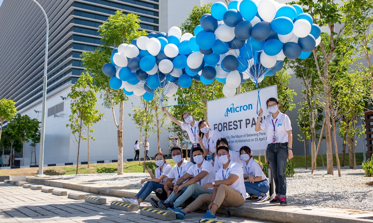 Micron team members in Malaysia gathered under blue and white balloons