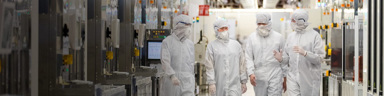 Micron employees having a conversation while wearing cleansuits