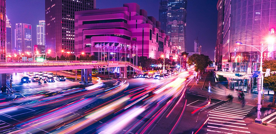 Bustling city at night. Streaks of car lights.